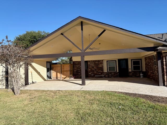 Covered patio with a gabled roof extending a Houston home's outdoor living space, built by IAS Boutique Remodeling.